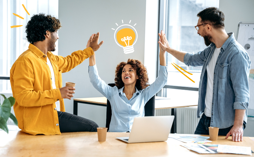 team high fiving in an office